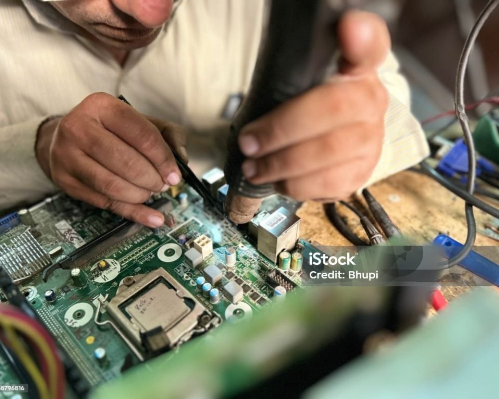 Close up of Man repairing Computer Motherboard. Electronic engineer repairs circuit board.